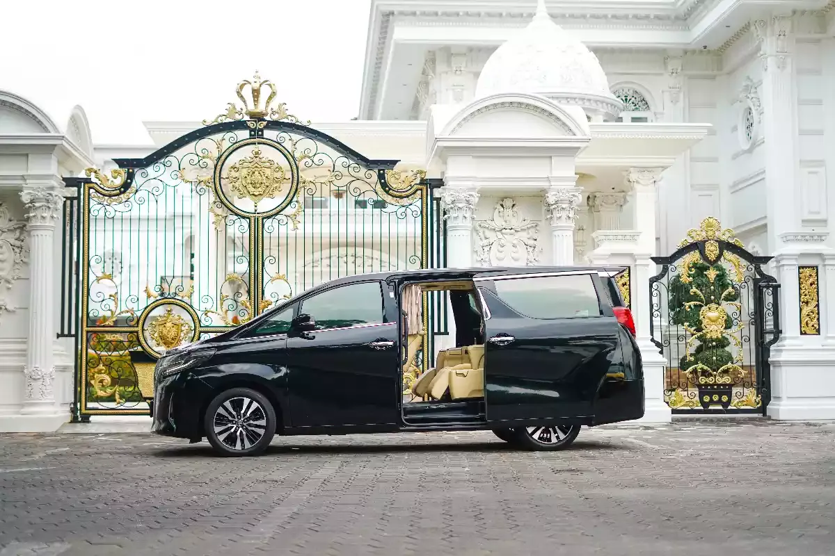 A black Alphard with its sliding door open, ready for boarding
