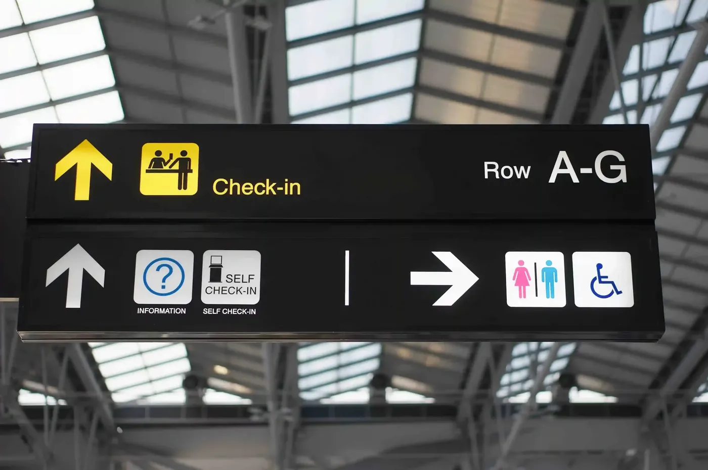 Terminal signage pointing to check-in rows A to G