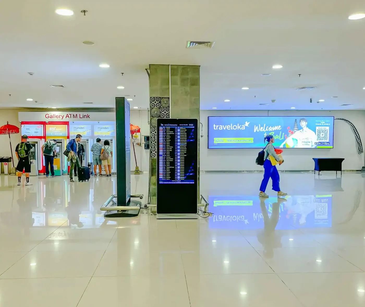 The Ngurah Rai arrivals hall with flight information screens