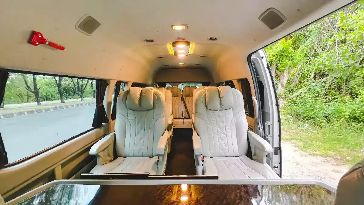 Reclining captain seats and a table inside a HiAce